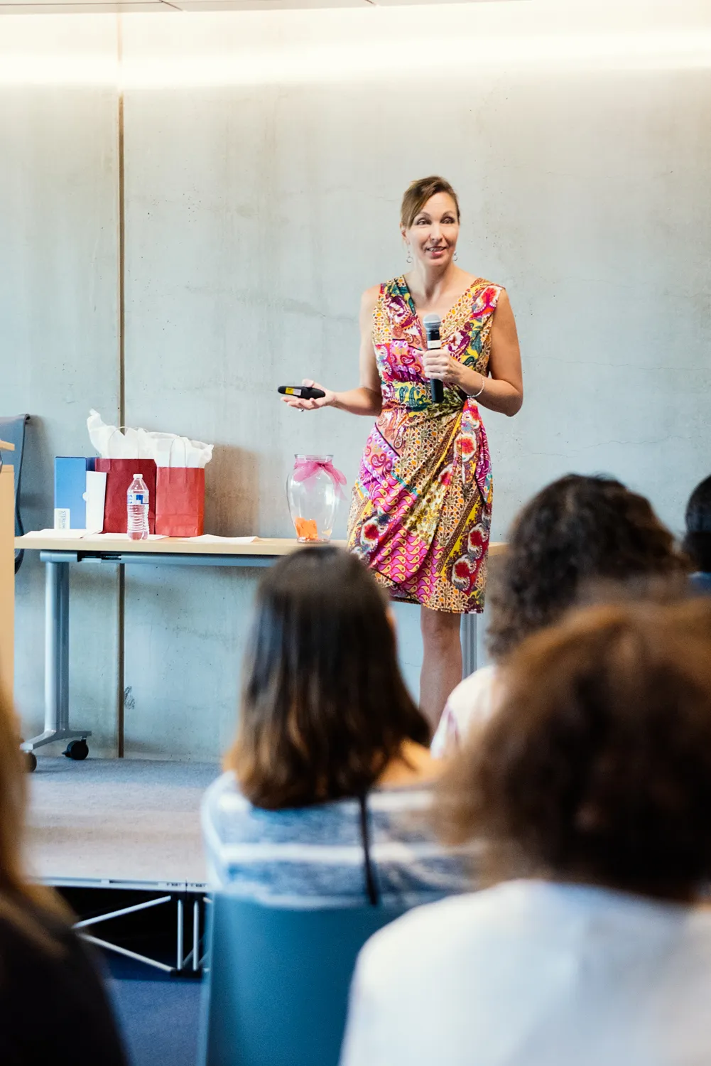 Stephanie Sims speaking at a workshop, microphone in hand